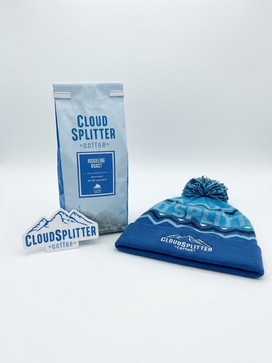 A bag of Cloudsplitter Coffee Ridgeline Roast, a logo sticker, and a BOCO Gear x CloudSplitter Pom Beanie.